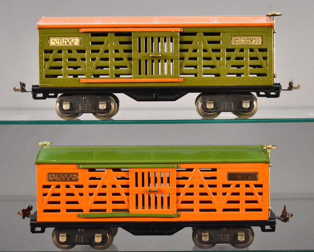 Two Lionel prewar standard gauge 513 cattle cars NICE: Two Lionel prewar standard gauge 513 cattle cars, one with orange sides, green roof, brass trim and nickel journals, the other with pea green sides, orange roof, brass plates and nickel trim, C7.