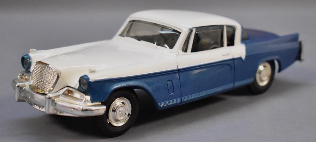 1956 Studebaker Hawk White over Blue Friction Bottom: 1956 Studebaker Hawk Snowcap White over Airforce Blue Metallic Original Friction Promo Car. Original issue dealer promo car with the trunk panel painted to match the roof color, dealer version only. E