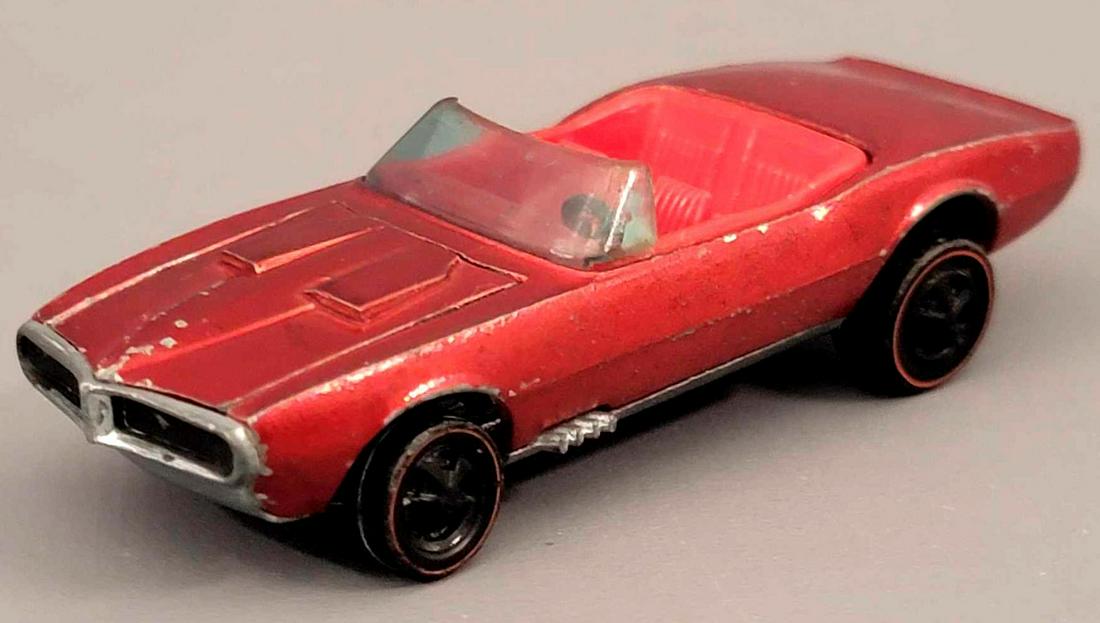Redline Hot Wheels HK Red Custom Firebird Loose: Redline Hot Wheels HK Red Custom Firebird with red interior. Car is in good condition with sattered chips and high edge wear in spots, wheels are missing all their chrome, base is clean with some ligh