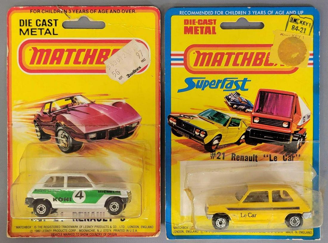 Group of two Lesney Matchbox #21 Renault LeCars on: Group of two Lesney Matchbox #21 Renault LeCars on Blister Packs. Both cars are minty on fair to good cars, the Yellow car has a blown out blister with tape repairs, the green & white one has a ni