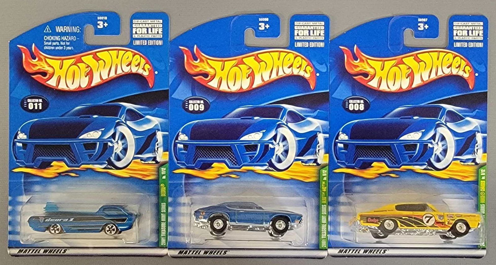 Group of three 2001 Treasure Hunt cars on cards (1 of 4)