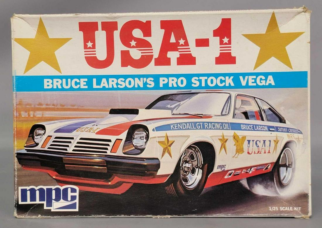 MPC 1-1758 USA-1 Bruce Larson's Pro Stock Vega 1/25: MPC 1-1758 USA-1 Bruce Larson's Pro Stock Vega 1/25 unbuilt in original box, kit appears complete with loose and on sprue parts, instructions sheet, and decal sheet. Box shows a little very light 