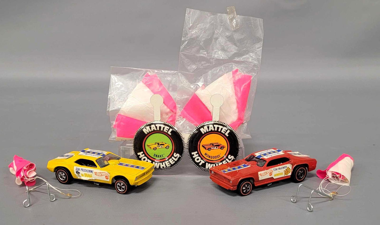 Redline Hot Wheels Snake and Mongoose Funny Cars with: Redline Hot Wheels Snake and Mongoose Funny Cars with Chutes and buttons. Snake is near mint with just a bit of wear to passenger side sticker, Mongoose is excellent with some chips to the drivers sid