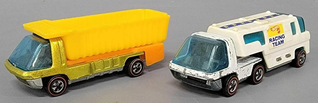 Group of two Hot Wheels Redline Heavyweights: Group of two Hot Wheels Redline Heavyweights. Group includes a good yellow dump truck that has scattered paint pops, good wheel with light chrome wear, clean base, glass has light scratches all over i