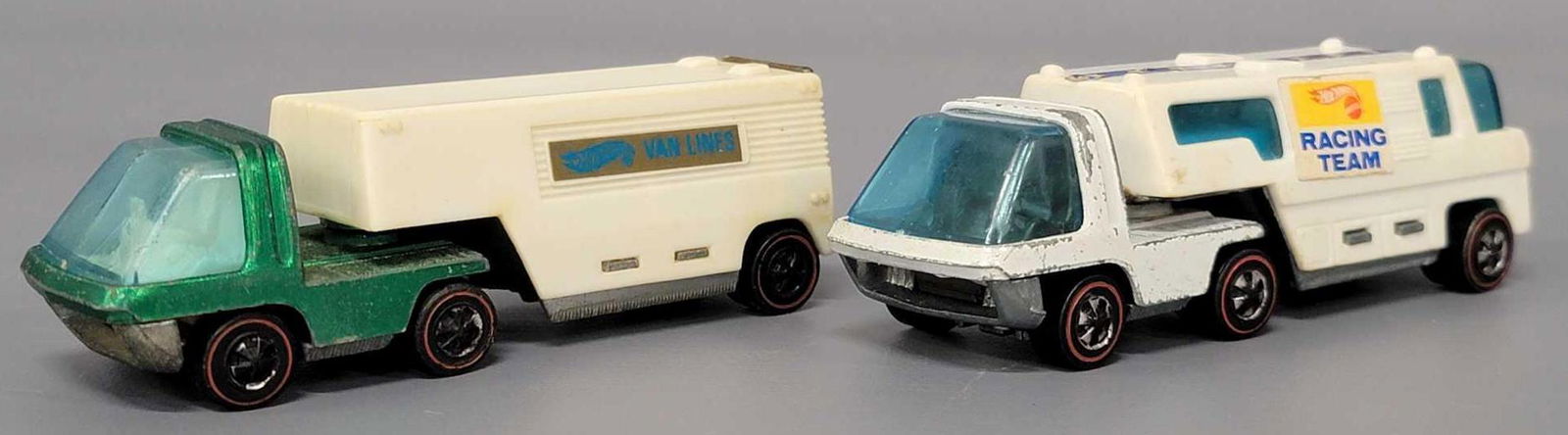 Group of two Hot Wheels Redline Heavyweights Race Team: Group of two Hot Wheels Heavyweights Race Team Trailer & Moving Van. Green Moving cab has white interior and is fair with high edge wear and a cracked windshield, trailer is white with light yello