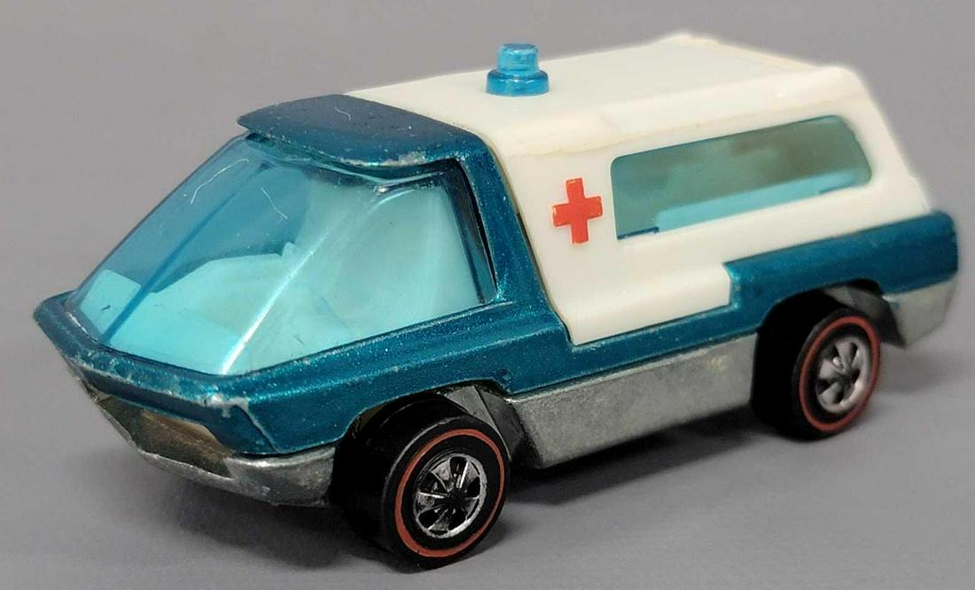 Hot Wheels Heavyweights Redline Aqua Ambulance with: Hot Wheels Heavyweights Aqua Ambulance with white interior. Car has light high edge wear to front , roof edge and rear tail lights, wheel chrome is good, with center chrome loss, excellent base.