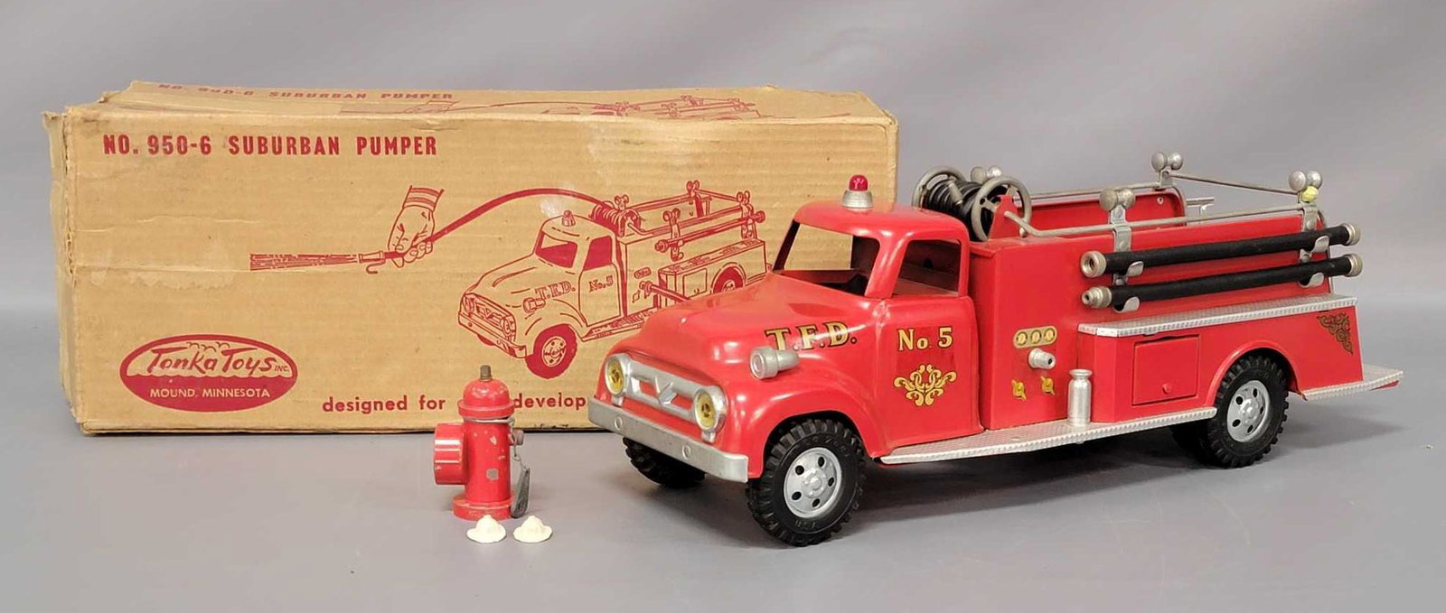 1950s Tonka Fire Suburban Pumper No. 950-6 with: 1950s Tonka Fire Suburban Pumper No. 950-6 with original box. Truck is in excellent condition with just a small amount of paint wear. The biggest issue is some light scratches on the passenger side co