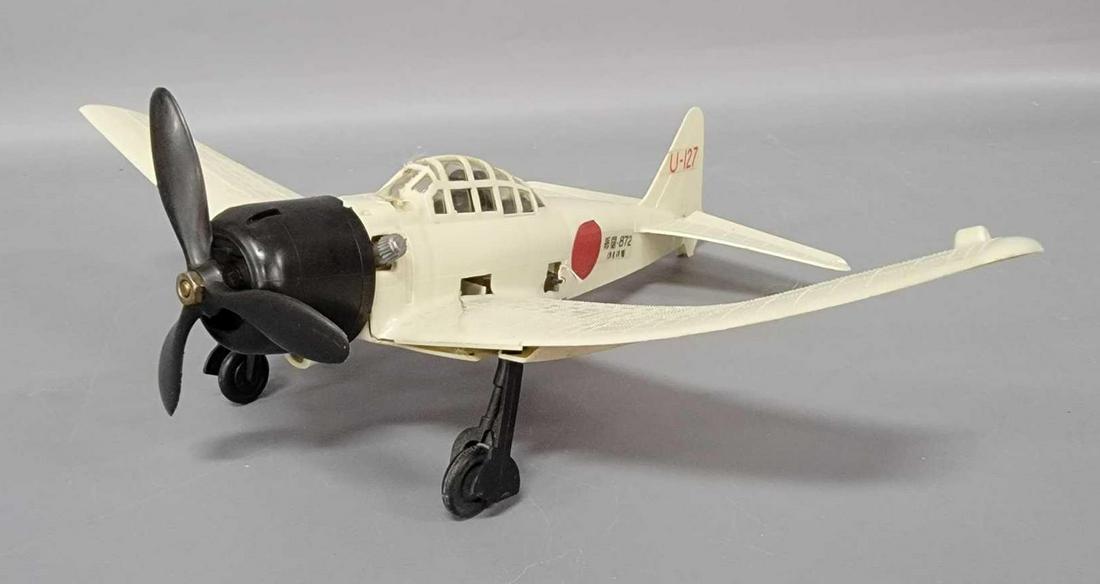 Vintage Cox gas powered tethered Japanese Zero fighter: Vintage Cox gas powered tethered Japanese Zero fighter airplane, wings are curled. Plane shows little play wear, starter winds, engine turns over.