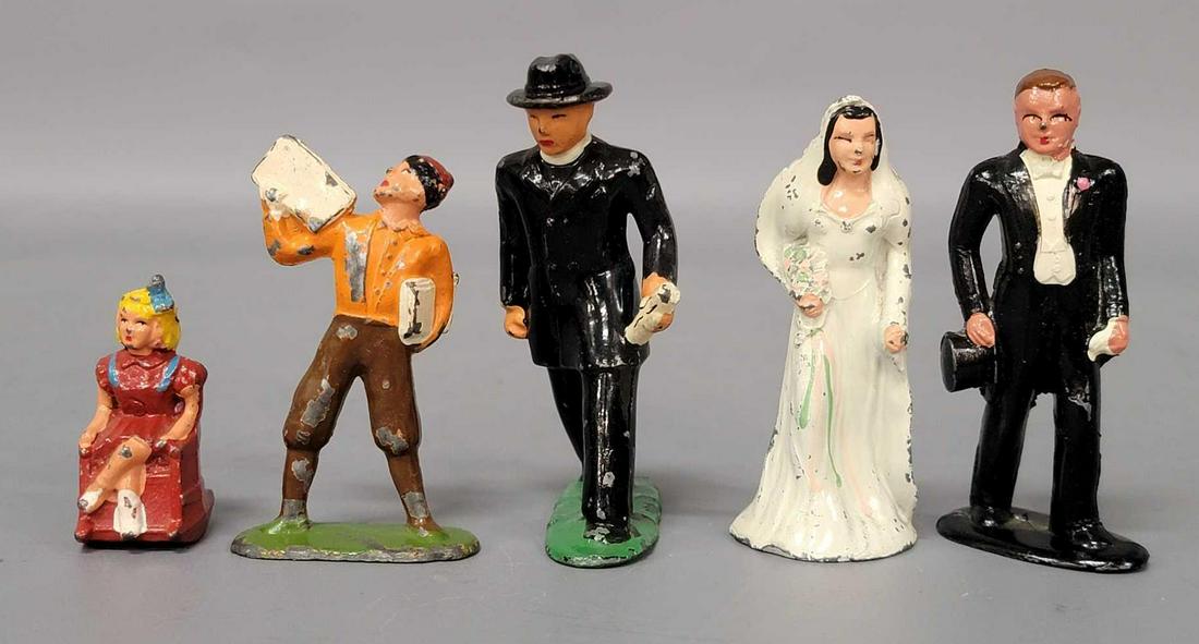 Barclay lead minister bride groom girl in rocking chair: Barclay lead minister, bride, groom, girl in rocking chair, newspaper boy, figures. Really nice clean and shiny group of people with a small amount of paint loss to figures.