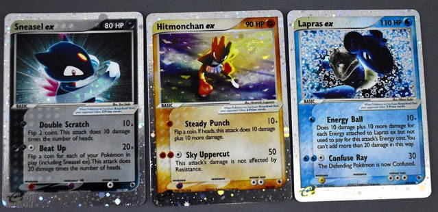 Group of three Original Pokemon Holo Hologram cards: Group of three Original Pokemon Holo Hologram cards 2003. Group includes 98/109 Hitmonchan ex, 99/109 Lapras ex and 103/109 Sneasel ex. Cards are in nice shape but not mint.