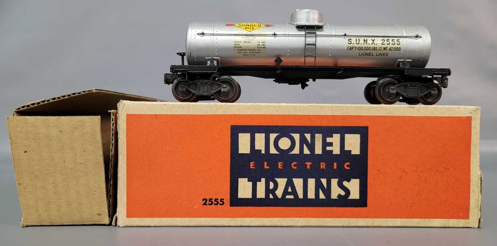 Postwar Lionel O gauge 2555 Sunoco tank car in original: Postwar Lionel O gauge 2555 Sunoco tank car in original box with insert, C7. Early production with flying shoe trucks. Frame is slightly curled. Tank is clean and shiny with near perfect decals. Box h