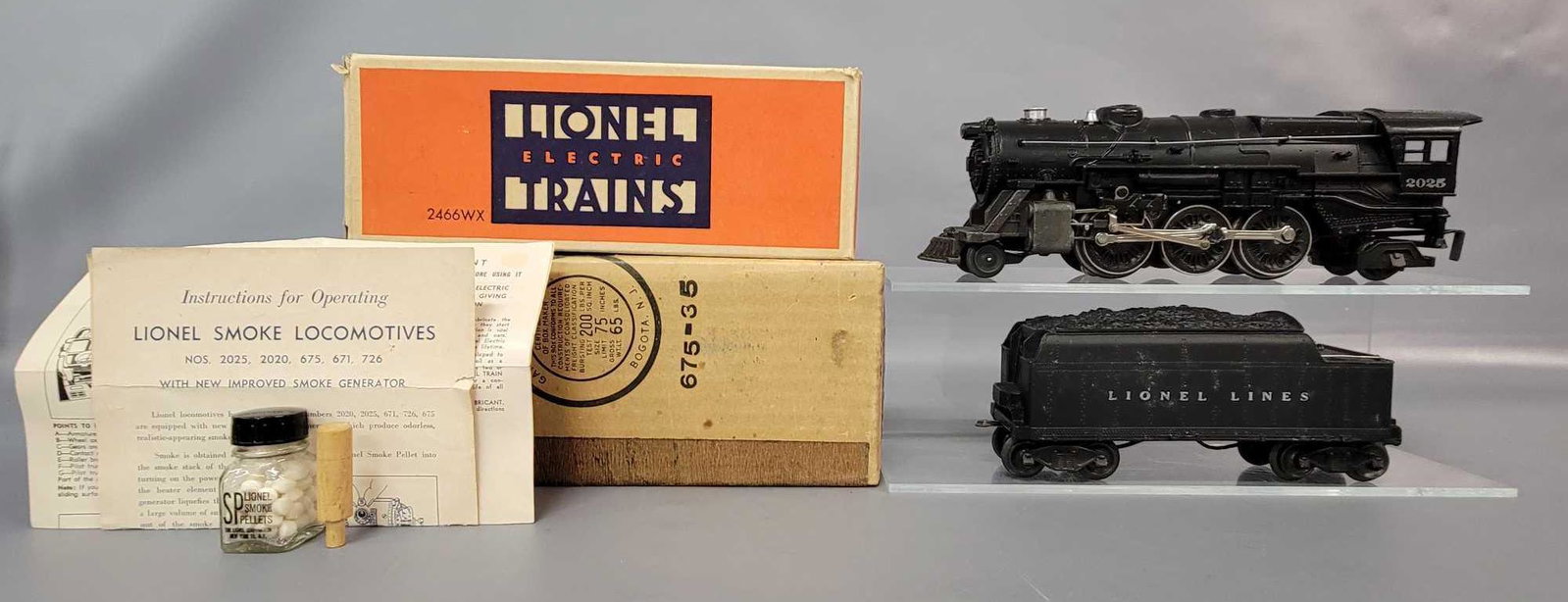 Postwar Lionel O gauge 2025 and 2466WX steam loco and: Postwar Lionel O gauge 2025 and 2466WX steam loco and tender in original boxes with inserts and instructions sheets. Loco is super clean C7, tender is super clean and stronger C6. Boxes show very ligh