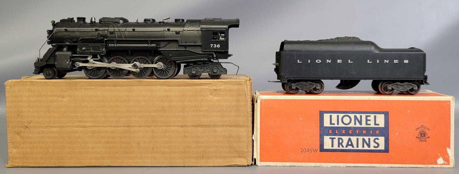 Postwar Lionel O gauge 736 and 2046W steam locomotive: Postwar Lionel O gauge 736 and 2046W steam locomotive and tender in original boxes with inserts, instructions sheet, and wooden tamper. Trains are super clean, C7. Boxes show a little very light wear,