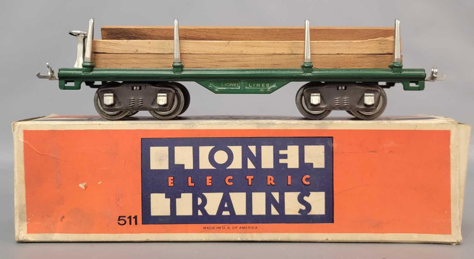 Prewar Lionel Standard Gauge 511 flatcar with lumber: Prewar Lionel Standard Gauge 511 flatcar with lumber load, in green with gold rubber stamp lettering and number, nickel trim. Much stronger C6 with stronger paint than normal. Nice clean and shiny car