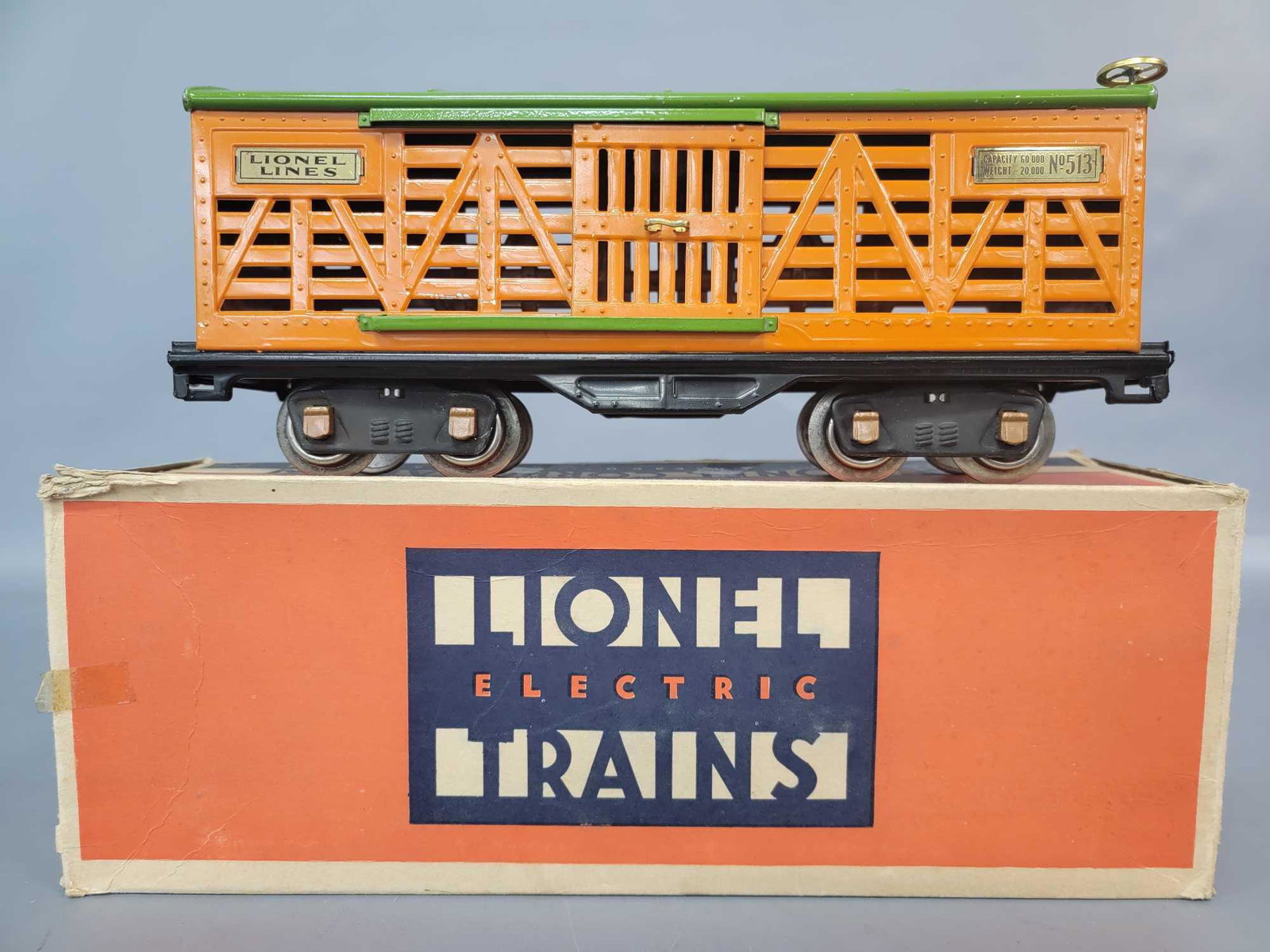 Prewar Lionel Standard Gauge 513 cattle car in original: Prewar Lionel Standard Gauge 513 cattle car with brass plates and trim, copper journals, really clean and shiny C7. Box has seperated seam, older tape, torn inner coupler protection flap, still a nice