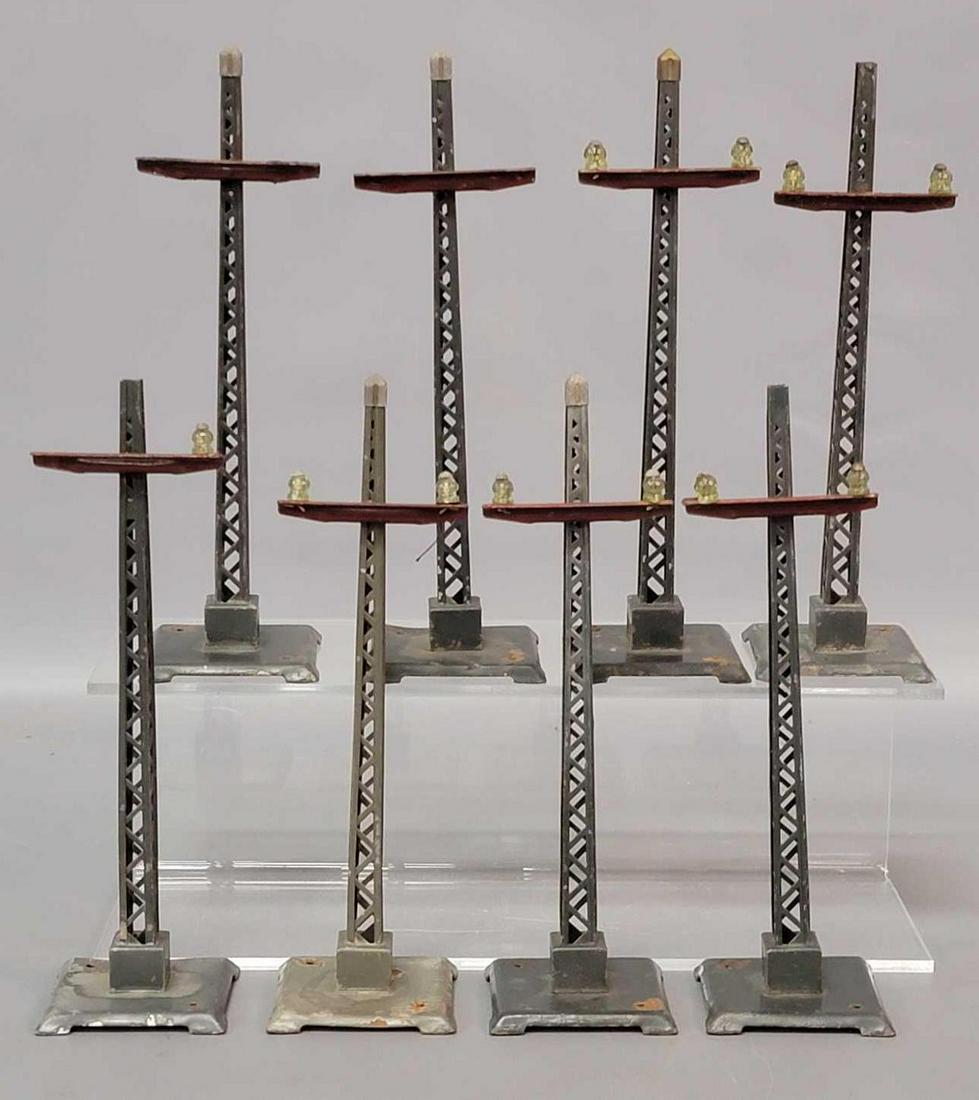 Eight prewar Lionel 60 telegraph poles in gray and red: Eight prewar Lionel 60 telegraph poles in gray and red, missing five glass insulators and three finials, varrying degrees of C6.