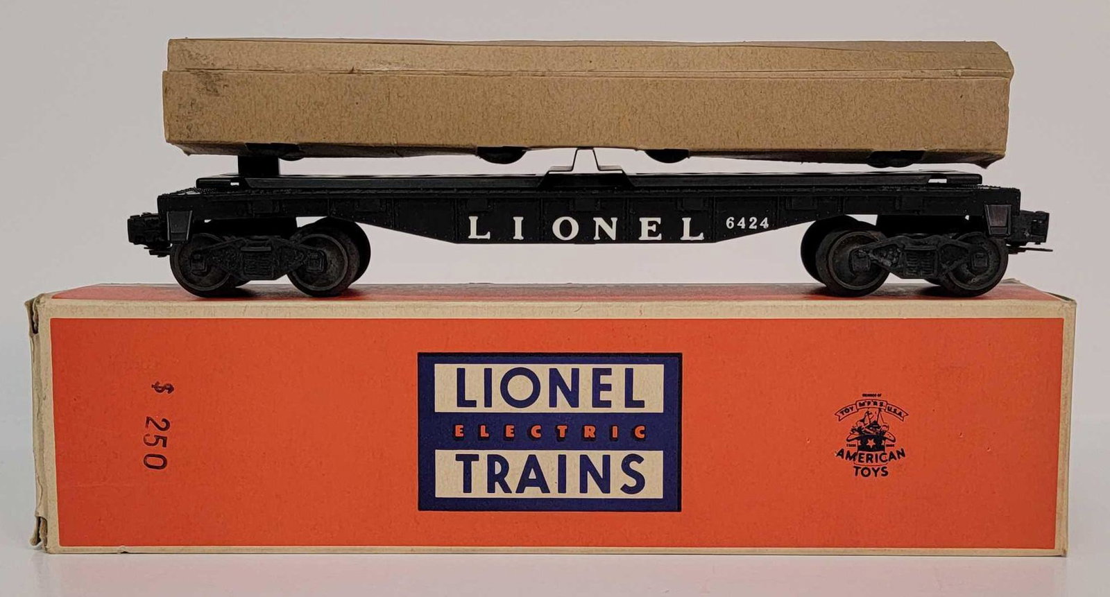 Unrun postwar Lionel O gauge 6424 automobile flat car: Unrun postwar Lionel O gauge 6424 automobile flat car with autos in original cardstock sleeve, unrun C9-10 with an excellent plus original box with bold lettering.