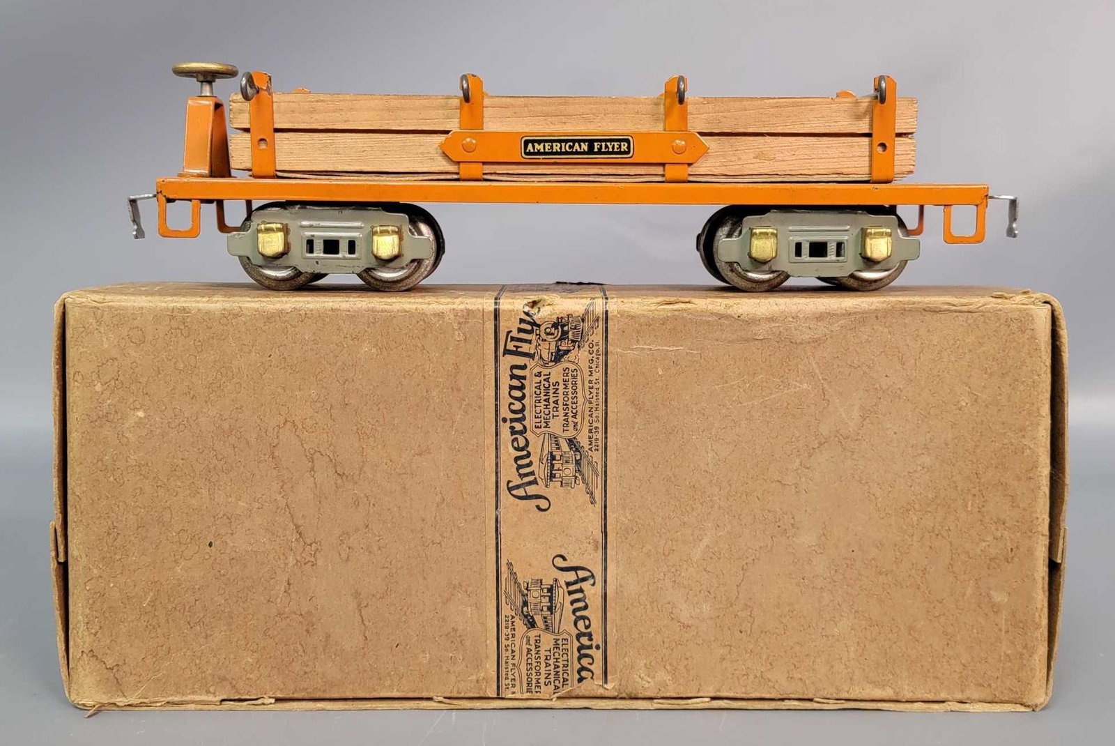 Prewar American Flyer Narrow Gauge 3216 log car in 3080: Prewar American Flyer Narrow Gauge 3216 log car with log load. 3216 orange log car with original load and restraints, decal lettering, rubber stamp number, patent numbers decal, gray truck frames, bra