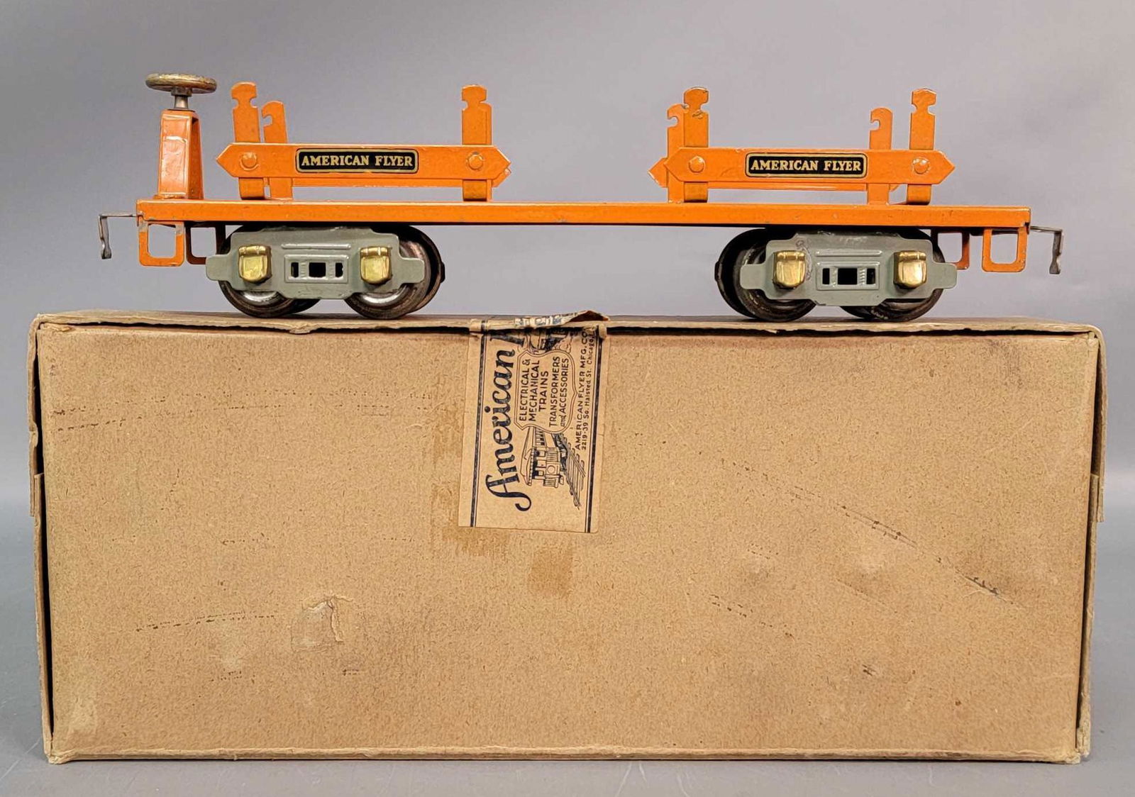 Prewar American Flyer Narrow Gauge 3206 log car in: Prewar American Flyer Narrow Gauge 3206 log car in original box, C7. Orange body, steps, uprights, support, orange crossbars with decal lettering, gray truck frames, gold painted brake wheel, brass jo