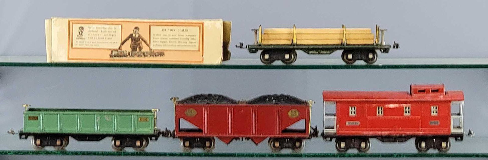 Lionel prewar standard gauge 511 512 516 517 freight: Lionel prewar standard gauge freight cars to include 511 dark green lumber car with original load, 512 peacock gondola, 516 red hopper and 517 caboose with one worn 511 box, C5-6 as seen in the photos