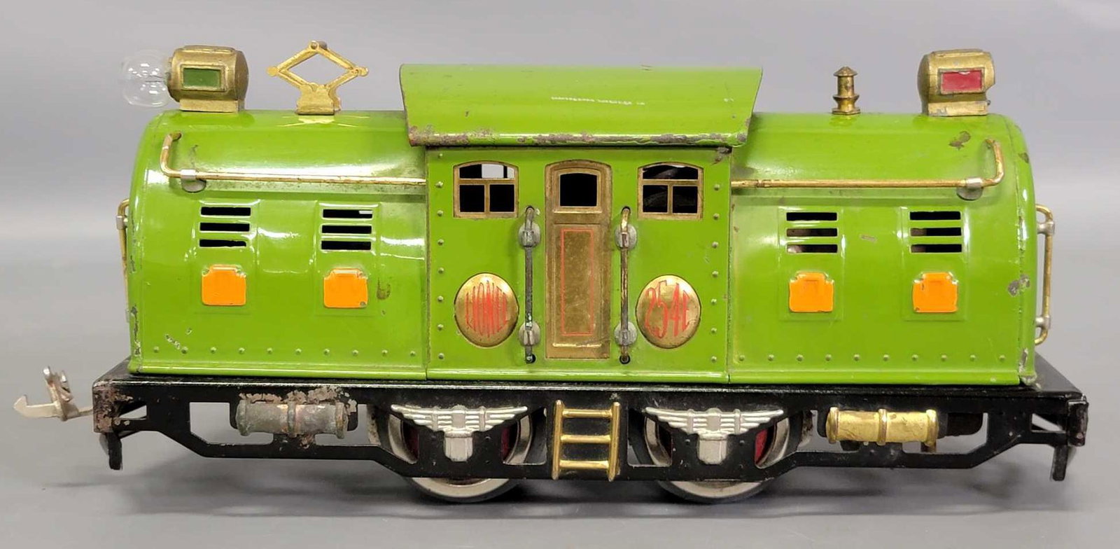 Lionel prewar O light green 254E electric locomotive: Lionel prewar O light green 254E electric locomotive with orange hatches, C6 with minute fatigue on one headlight casting.