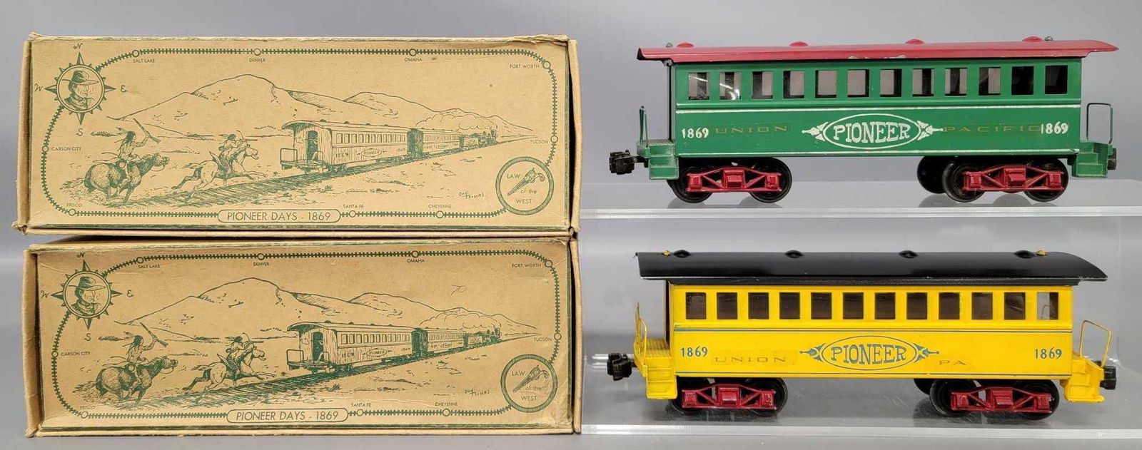 Two Thomas Industries O gauge passenger cars in: Two Thomas Industries O gauge passenger cars in original boxes to include one yellow and one red 1869 tinplate coach, C7, with two very good original boxes as seen in the photos.
