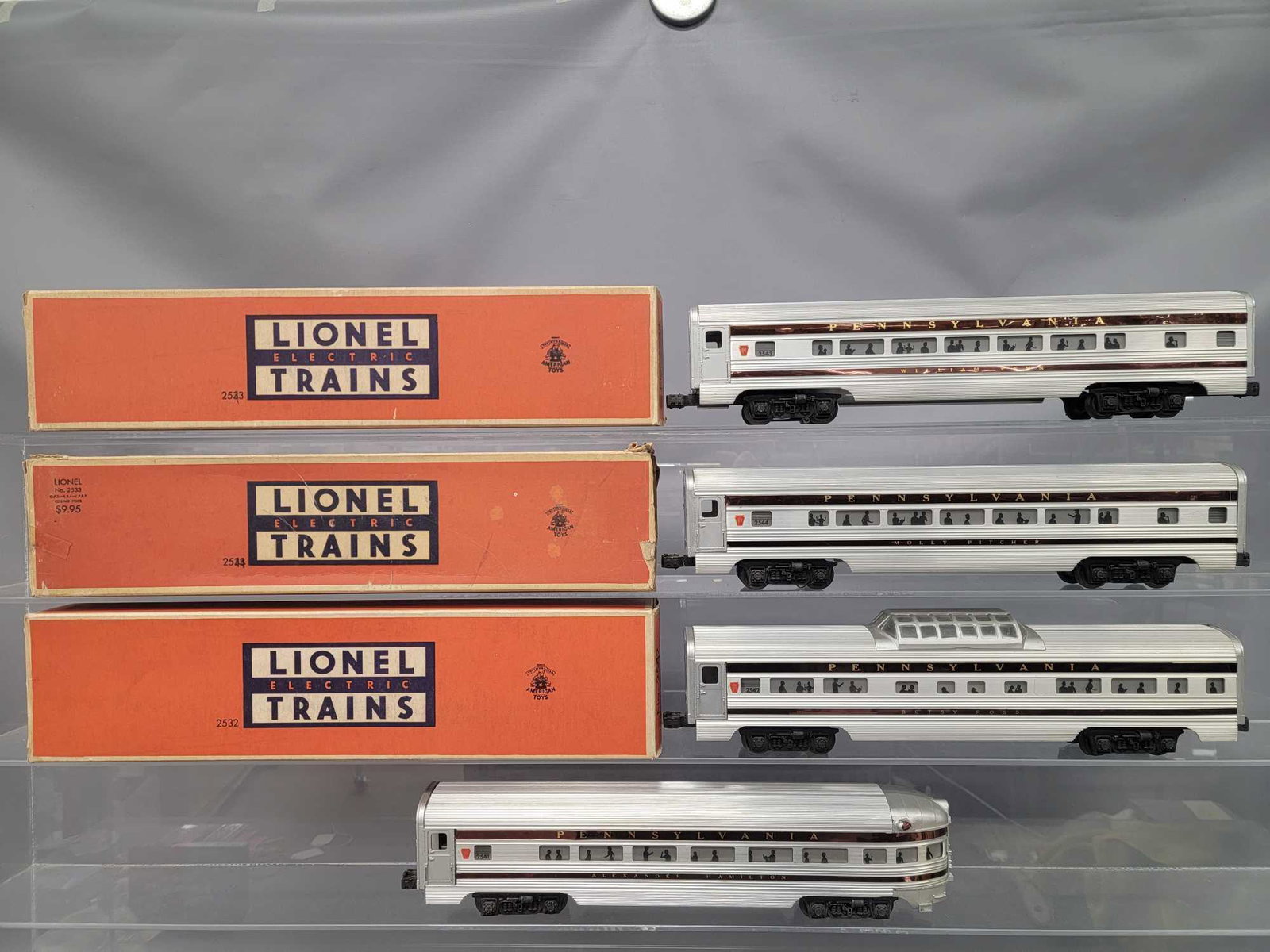 Lionel postwar O passenger cars in original boxes with: Lionel postwar O extruded aluminum passenger cars in original boxes. Three of the four cars were modified possibly by Madison hardware. They are the regular Pullman and vista dome cars that have been 