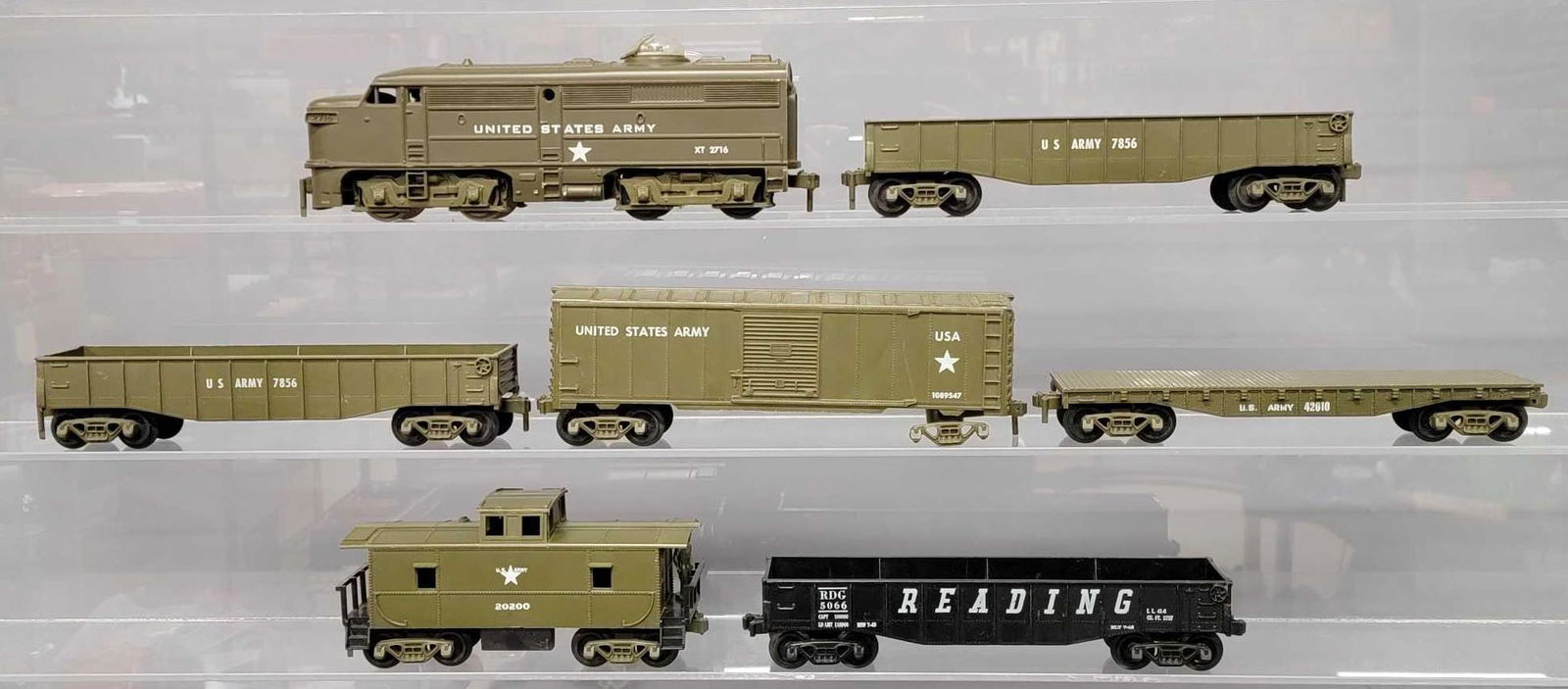 Group of mixed condition Kusan O gauge Army trains: Group of mixed condition Kusan O gauge Army trains to include and Alco FA unit with rear steps broken off of one side, two 7856 gondolas, 42010 flat car, box car with one mostly missing truck assembly