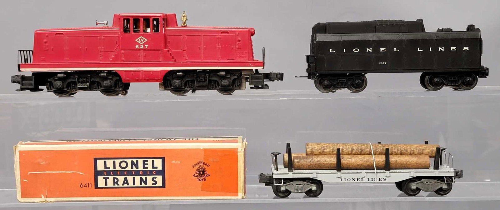 Lionel postwar O 627 233W and 6411 with OB: Lionel postwar O 627 Lehigh Valley 44 tonner, 233W with all steps intact and 6411 flat car with logs, all are C6+ with a worn original box.