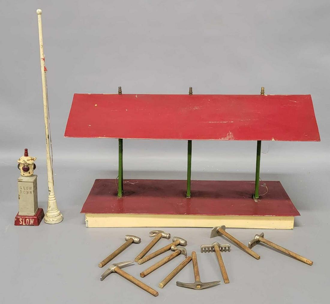 Group of 1920's home made standard gauge train: Group of 1920's home made standard gauge train accessories to include a freight shed, stop light and a group of wooden handle track gang tools. The freight shed measures 18 inches long, 8 inches w