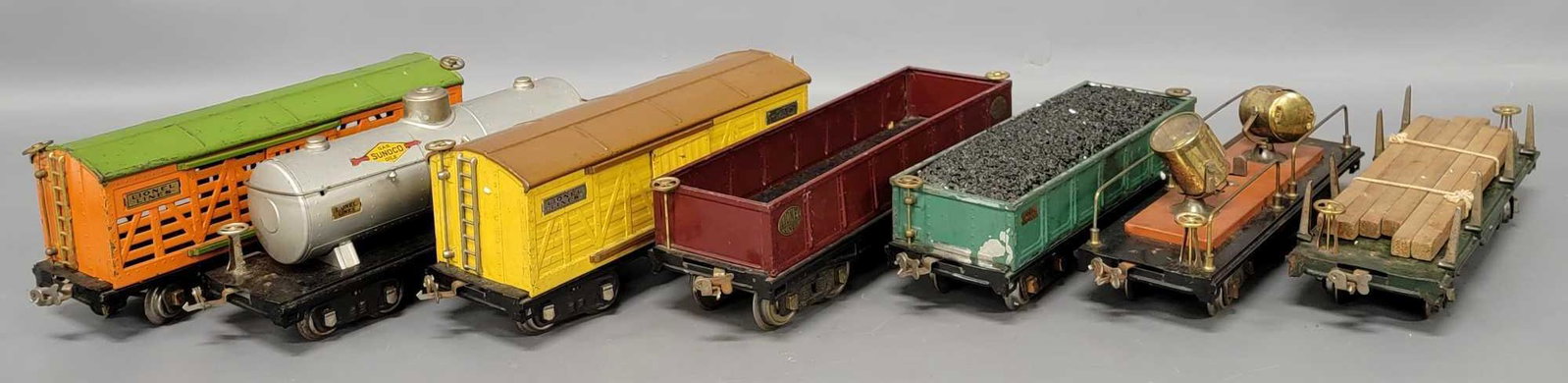 Group of Lionel standard gauge freight cars: Group of Lionel standard gauge freight cars to include 212 wine gondola, 512 peacock gondola with homemade coal load, 515 Sunoco tank car, 520 Terra Cotta searchlight car, 511 dark green lumber car wi