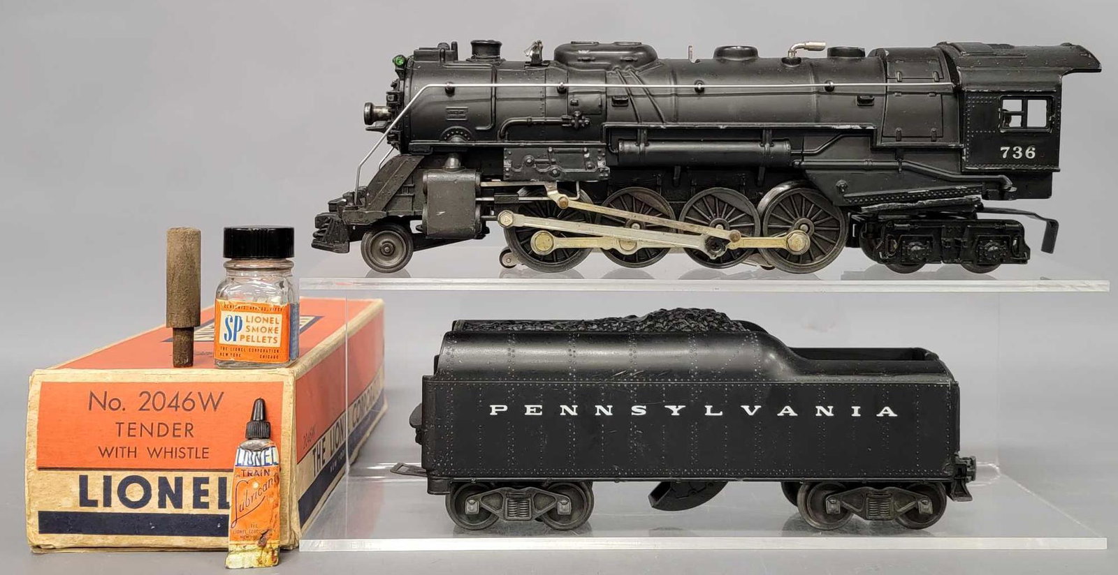 Lionel postwar O 736 steam locomotive with 2046W PRR: Lionel postwar O 736 steam locomotive with 2046W PRR tender and a 2046W original box. The locomotive is a later unit with plastic trailing truck side frame and shows light run time but is C6-7. The te