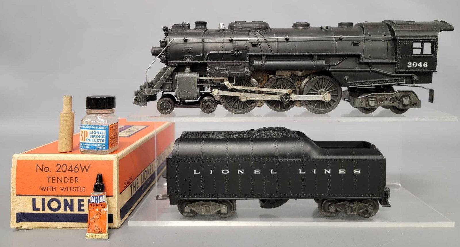 Lionel postwar O 2046 steam locomotive with 2046W: Lionel postwar O 2046 steam locomotive with 2046W tender and a 2046W original box. The locomotive shows moderate run time but has numerous small touch ups on raised edges, C6. the tender shows light r