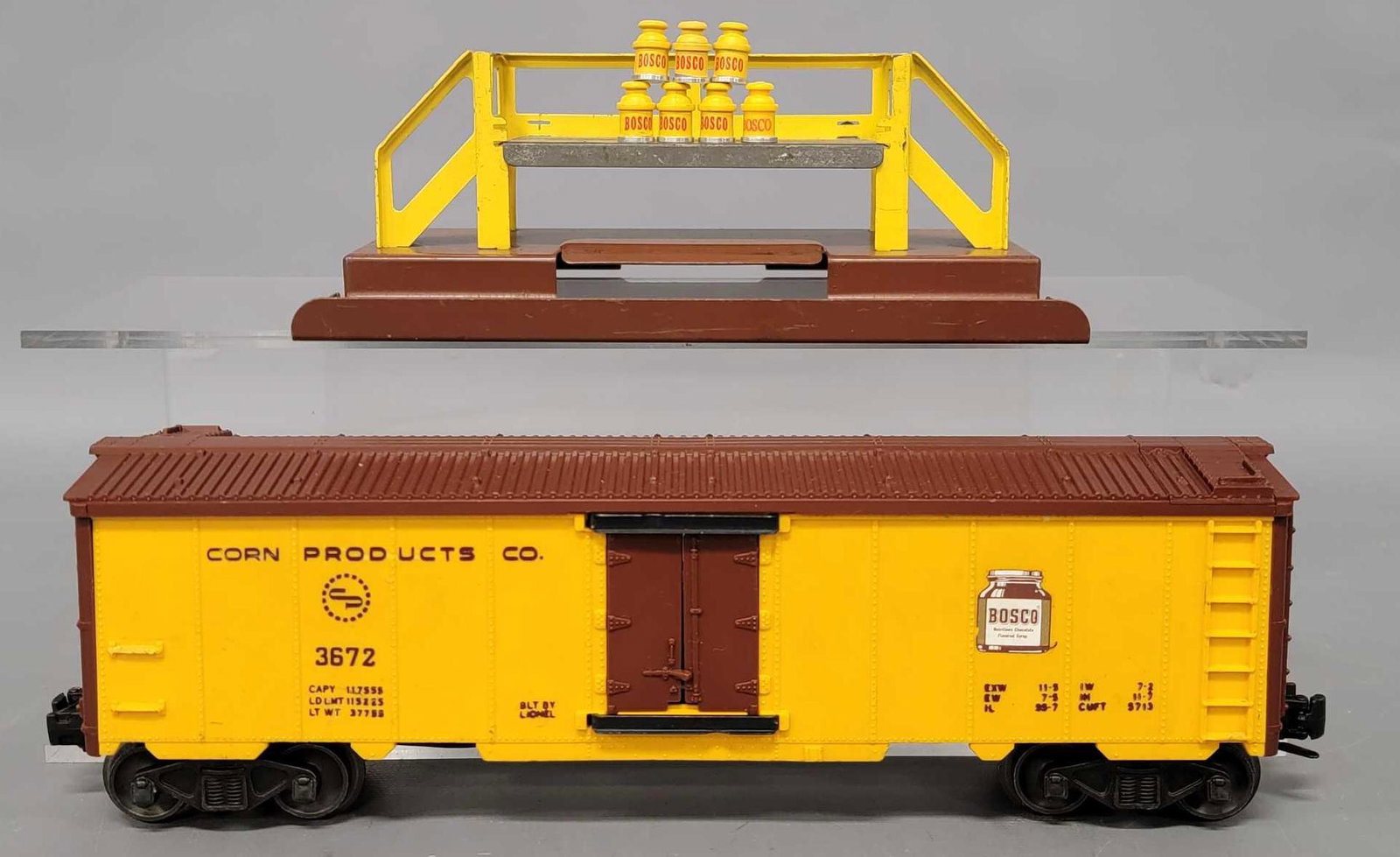 Lionel postwar O 3672 Bosco car with platform: Lionel postwar O 3672 Bosco car with platform, the car has a crack on one side to the left of the door and comes with a platform and seven nice Bosco cans, C6