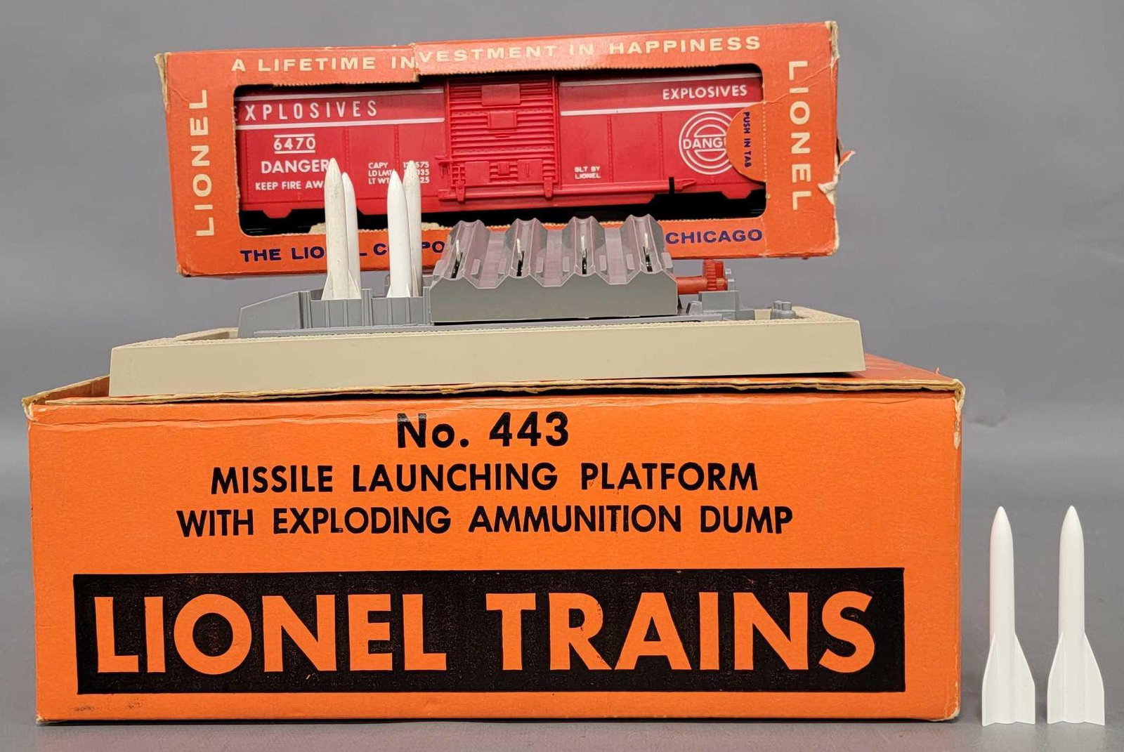 Lionel postwar O 443 missile launching platform in OB: Lionel postwar O 443 missile launching platform in original box with 943 exploding ammunition dump plus a loose 448 missile firing range set with six missiles and a 6470 exploding target car in a roug
