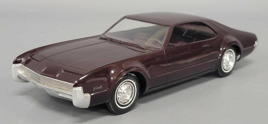 1966 burgundy Oldsmobile Toronado dealer promo coaster car (1 of 7)