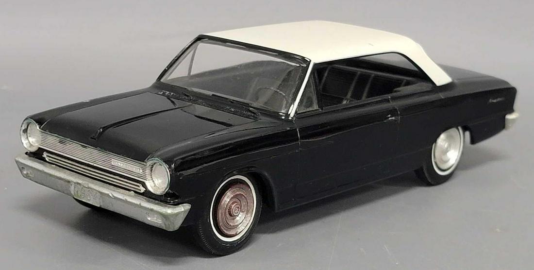 1964 black AMC Rambler 440 dealer promo friction car: 1964 black with white roof AMC Rambler 440 dealer promo friction car, car is very good with light crazing on the hood, light scratches on the trunk, a few scattered nicks in the roof paint.
