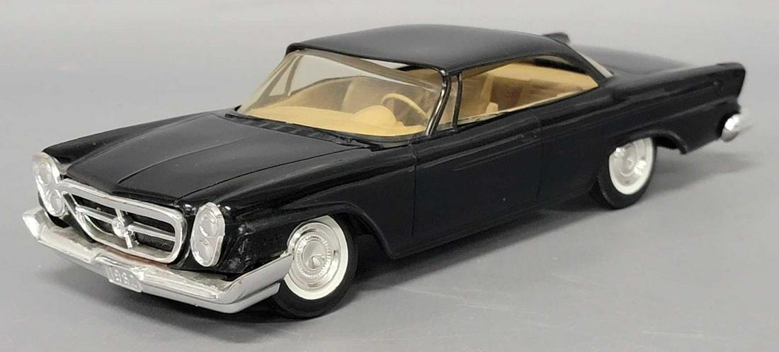1962 black Chrysler 300 dealer promo coaster car with torsion bars on front: 1962 black Chrysler 300 dealer promo coaster car with torsion bars on front, car is excellent with very light warping, glass is drooping a bit as well, front axles are rusted slowing the wheels from t