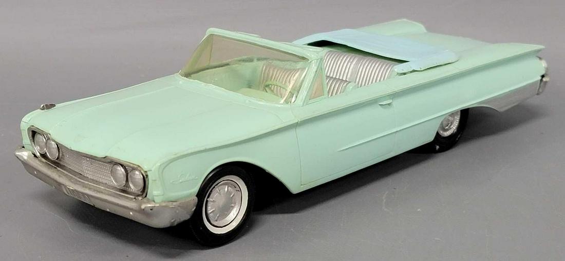 AMT 1960 light blue Ford Sunliner convertible dealer promo friction car: AMT 1960 light blue Ford Sunliner convertible dealer promo friction car, car is very good with light warp in areas, drivers side front marker light is missing, axles are rusty, hood marker lights are