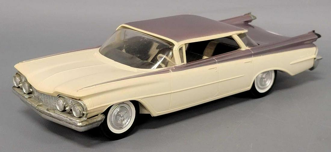 1959 two tone Oldsmobile Ninety eight dealer promo coaster car: 1959 two tone lavendar and white Oldsmobile Ninety eight dealer promo coaster car, car is very good to excellent with light warp to trunk and hood.