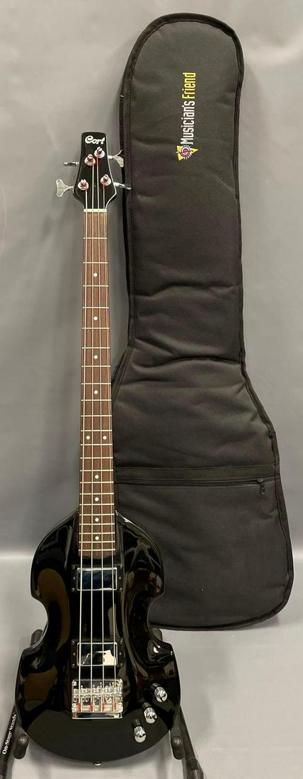 Modern Cort bass guitar with gig bag: Modern Cort bass guitar with gig bag. The guitar is in excellent condition and does not appear to have been played very much at all. Serial number 6116468, made in Korea. The gig bag is in excellent c
