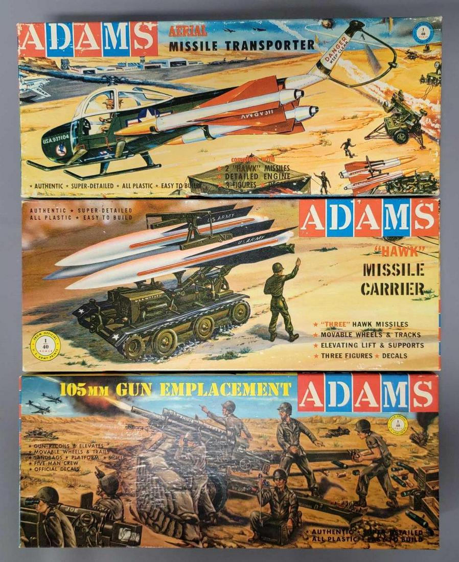 Three Adams Military model kits in original boxes: Three Adams Military model kits in original boxes, includes k152 105mm Gun Emplacement, K159 Hawk Missile Carrier and K158 Aerial Missile Transporter, all appear complete with some parts in handmade b