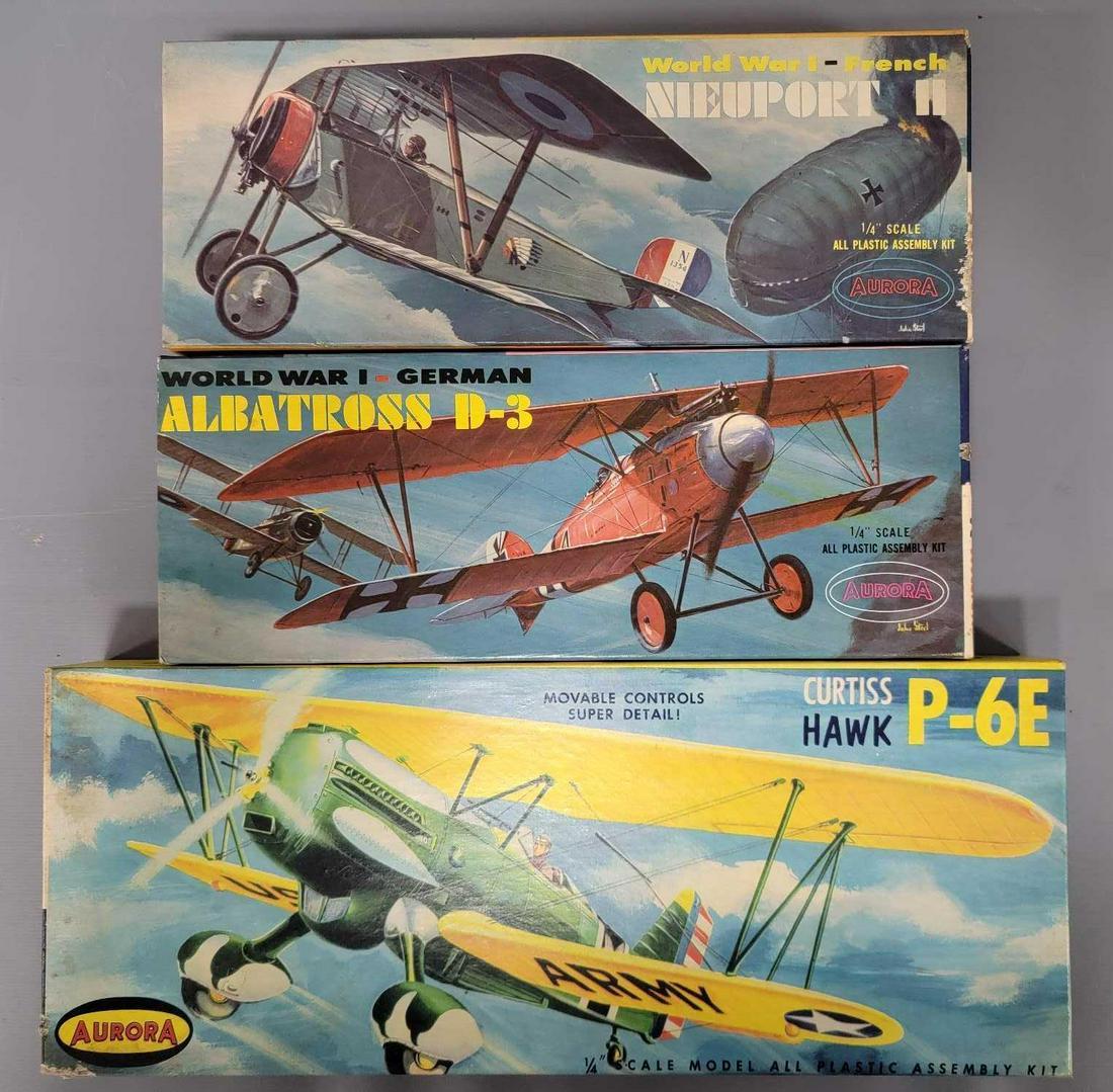Three vintage Aurora model plane kits in original boxes: Three vintage Aurora model plane kits in original boxes, includes 116-98 Curtiss Hawk P-6E, 104 Albatross D-3 and 101-100 Nieuport II, all appear to be complete with instructions and decals, boxes are