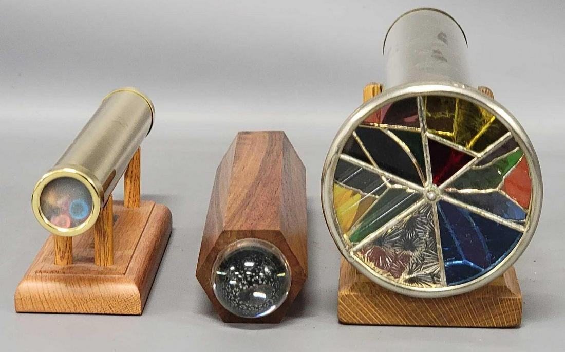 Three assorted brass and wood Kaleidoscopes: Three assorted brass and wood Kaleidoscopes, these appear to be modern, includes a brass piece that is 8 3/4 inches long x 1 1/4 inch wide, it has an inscription that reads American Traditions Signatu