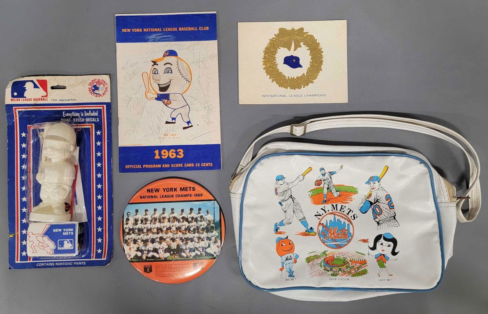 Collection of New York Mets baseball memorabilia: Collection of New York Mets baseball memorabilia, includes a large six inch New York Mets National League Champs 1969 card board backed button pin, a 1963 official program and scorecard that is marked