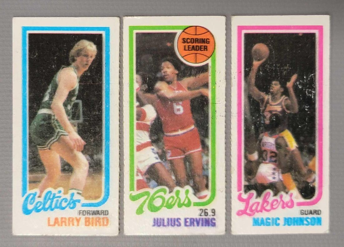 1980 Topps Larry Bird and Magic Johnson rookie cards perforated: 1980 Topps Larry Bird and Magic Johnson rookie cards perforated Cards are separated and all have smudged appearance in lettering and borders, all are lightly worn at edges and corners.
