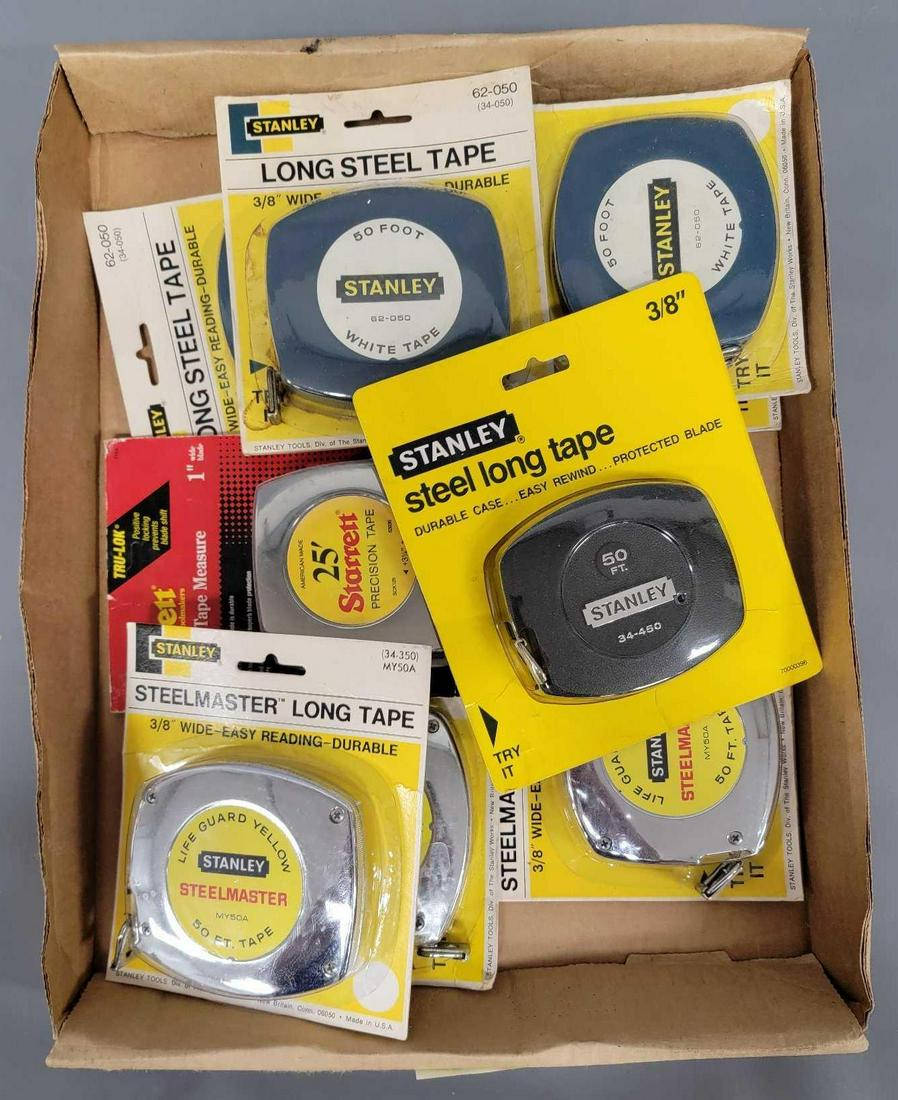 Nine mostly Stanley steel measuring tapes in original packaging: Nine mostly Stanley steel measuring tapes in original packaging, includes four Stanley 62-050 3/8 inch wide 50 foot tape measures with blue grey gray case, three Stanley MY50A 3/8 inch wide 50 foot ch