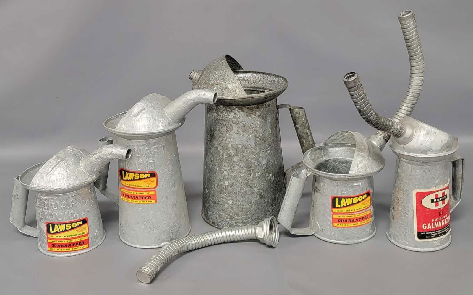 Five vintage galvanized metal oil cans including three labeled Lawson (1 of 8)
