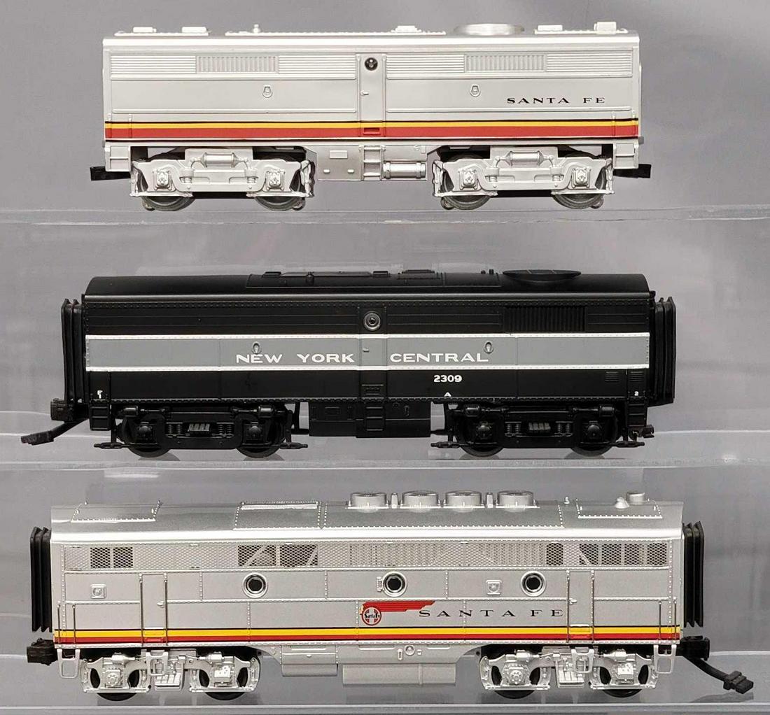 Three assorted brand and road name O Gauge FA-2 B units: Three assorted brand and road name O Gauge FA-2 B units, includes a K-Line Santa Fe lighted that is very good to excellent C6-7, an MTH Santa Fe with proto cord that is very good to excellent and an M