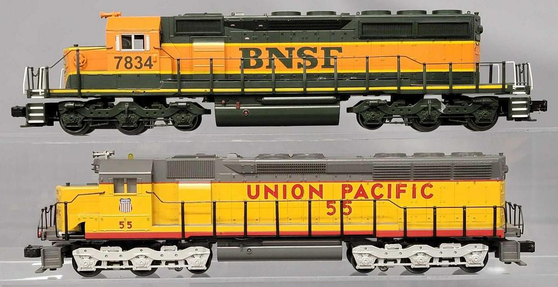 Two MTH O Gauge Diesel locomotives that need work: Two MTH O Gauge Diesel locomotives that need work, includes Union Pacific EMD SD45 diesel, every one on the mounting posts on the inside are broken off to some degree, the shell otherwise is in good c